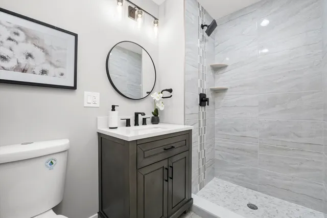a bathroom with a sink toilet and shower