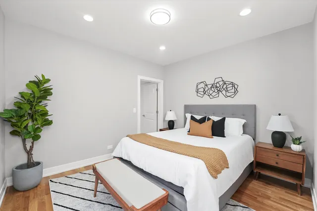 a bedroom with a bed and a potted plant