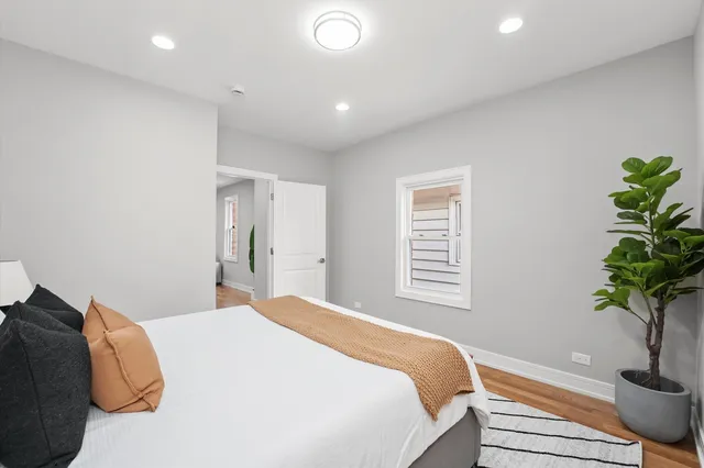 a bedroom with a bed and a potted plant