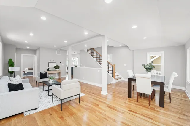 a living room with furniture a wooden floor and a table