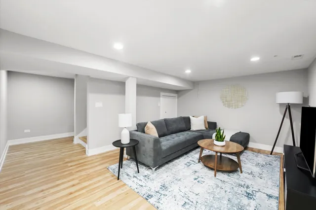 a living room with furniture and a wooden floor