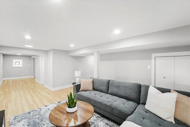 a living room with furniture and a potted plant