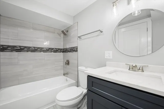 a bathroom with a sink a toilet and a bathtub