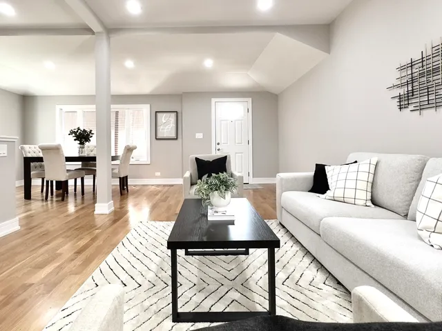 a living room with furniture and wooden floor