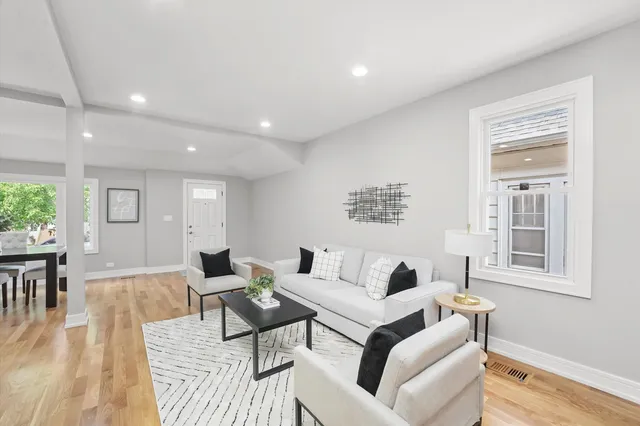a living room with furniture and a wooden floor
