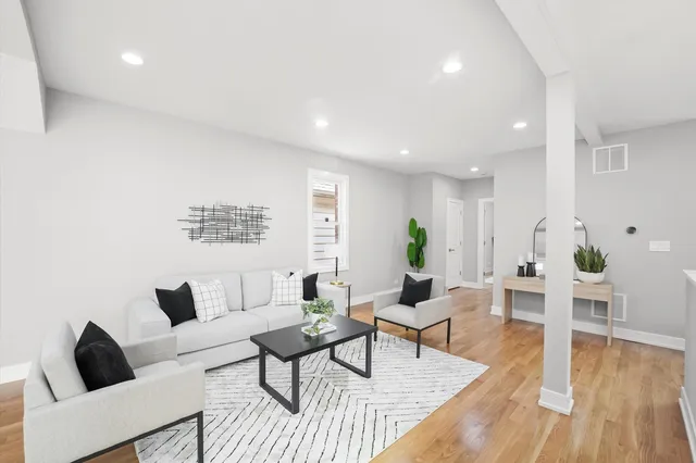 a living room with furniture and wooden floor