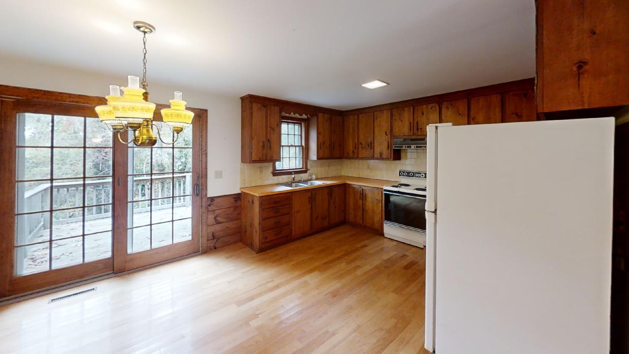 6 Old Hills Road Dennis, MA 02638 - Photo 14 of 45 a kitchen with stainless steel appliances granite countertop a refrigerator a sink dishwasher and a fireplace