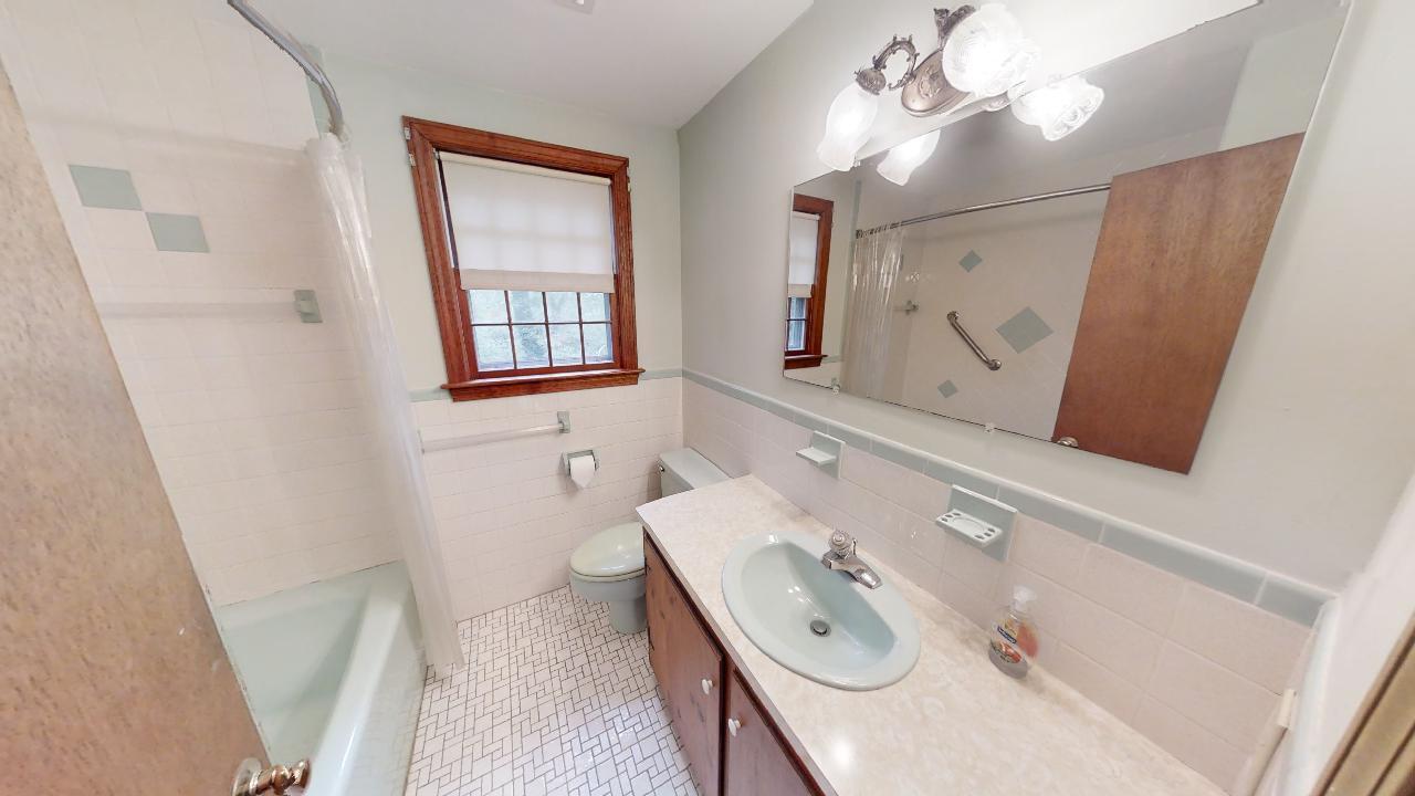 6 Old Hills Road Dennis, MA 02638 - Photo 22 of 45 a bathroom with a sink a mirror and a window
