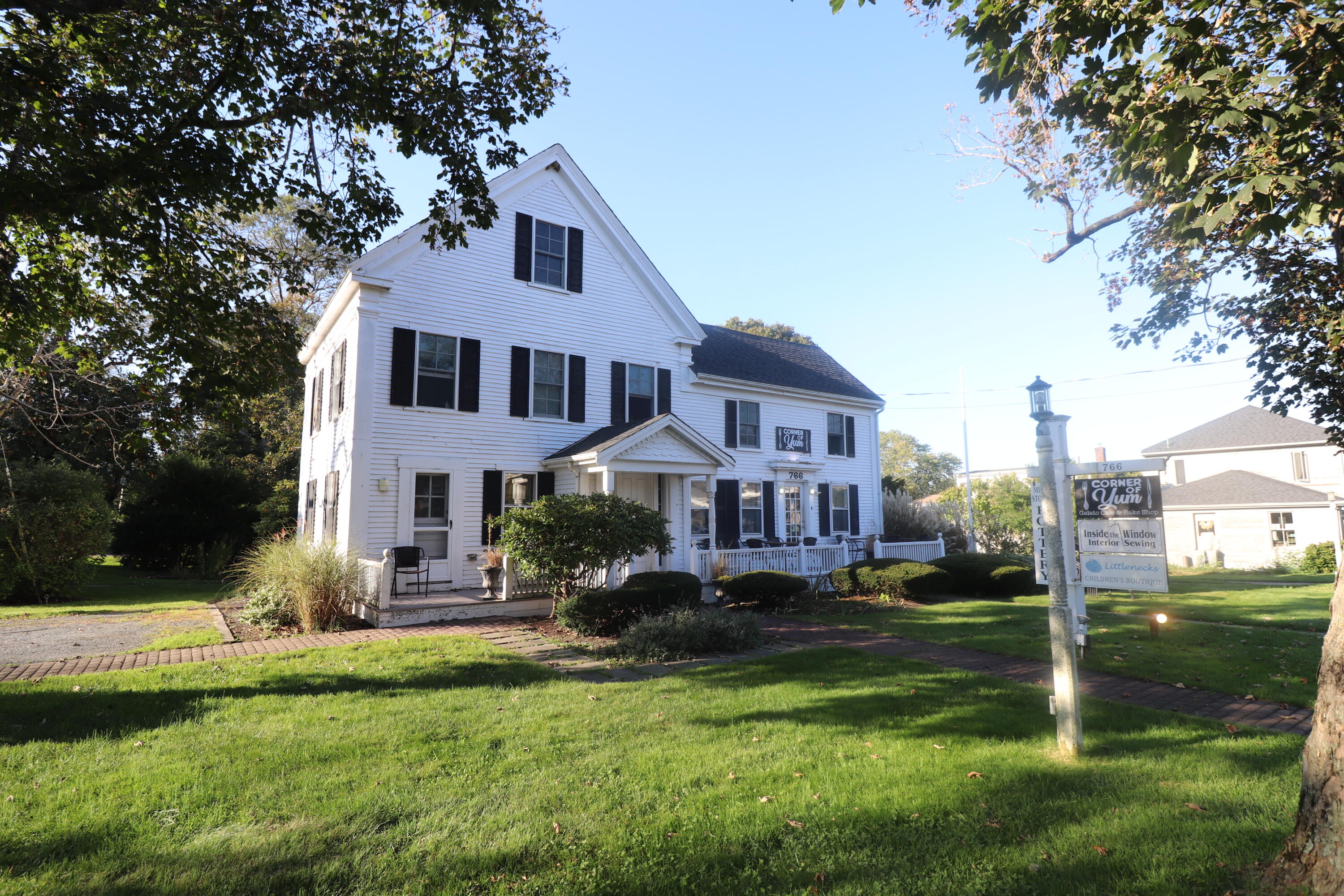 6 Old Hills Road Dennis, MA 02638 - Photo 39 of 45 a front view of a house with a yard table and chairs