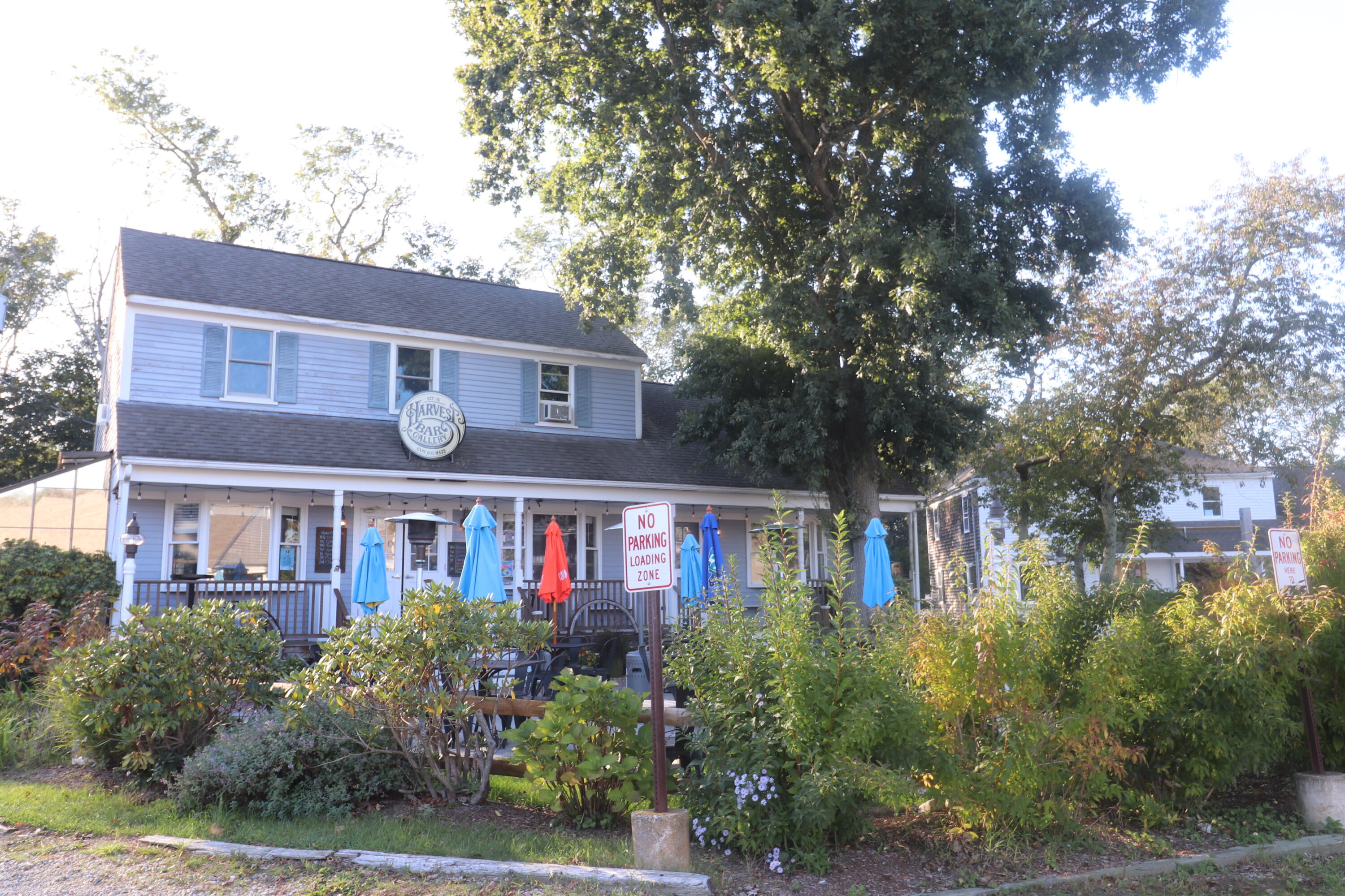 6 Old Hills Road Dennis, MA 02638 - Photo 42 of 45 a front view of a residential apartment building with a yard