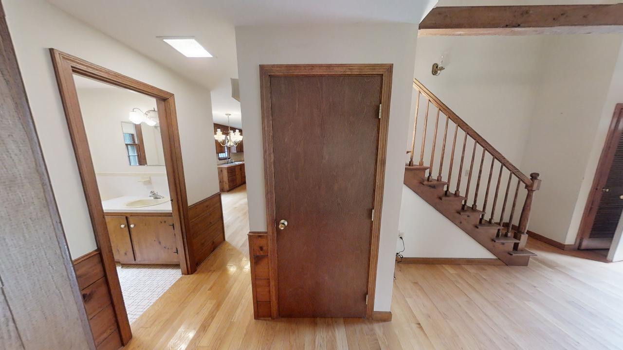 6 Old Hills Road Dennis, MA 02638 - Photo 9 of 45 a view of a hallway with wooden floor and stairs
