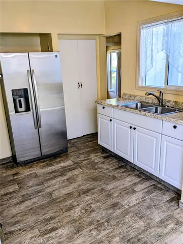 a kitchen with granite countertop a stove and a sink