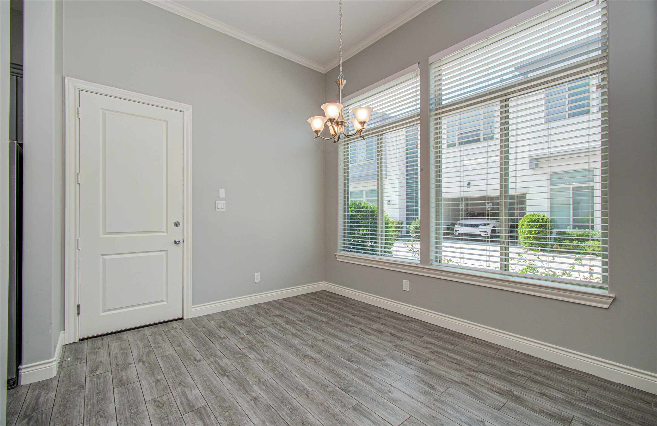 8903 Spring Knoll Forest Drive Houston, TX 77080 - Photo 21 of 29 a view of an empty room with wooden floor and a window