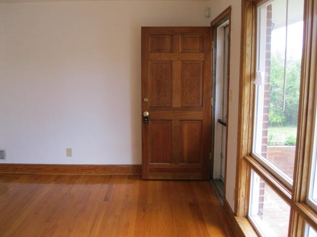 2147 Meadowbrook Road Northwest Roanoke, VA 24017 - Photo 11 of 17 an empty room with wooden floor and windows with curtains