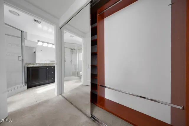 a view of a hallway to rooms