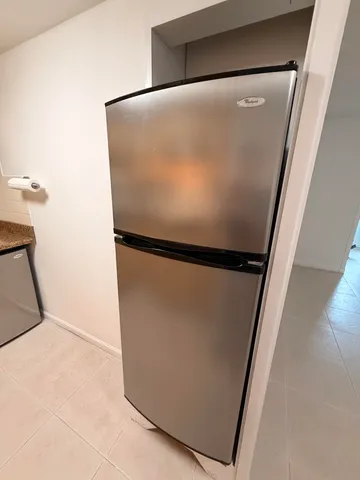 a view of empty room with wooden floor and furniture