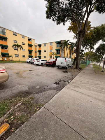 a car parked in front of a blue house