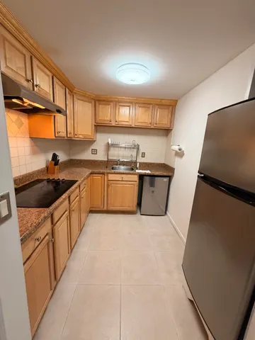 a kitchen with stainless steel appliances a sink stove and cabinets