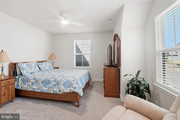 a bedroom with furniture and a window