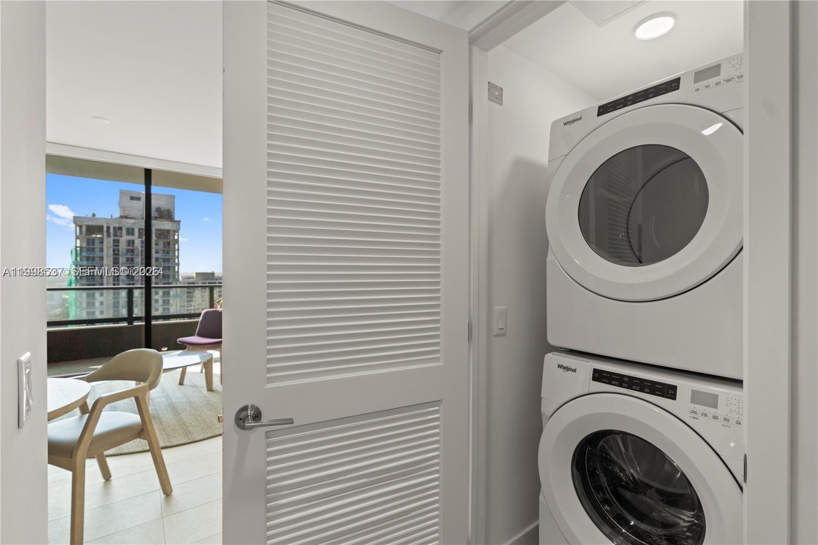 159 Northeast 6th Street, Unit 2403 Miami, FL 33132 - Photo 15 of 16 a view of a hallway with washer and dryer