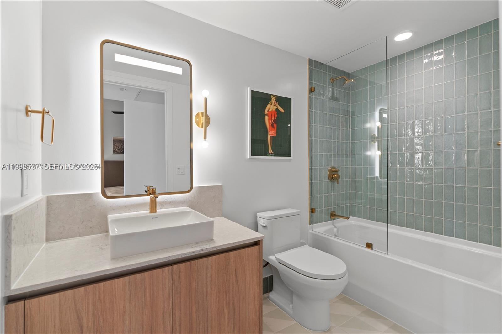 159 Northeast 6th Street, Unit 2403 Miami, FL 33132 - Photo 8 of 16 a bathroom with a sink a toilet and shower