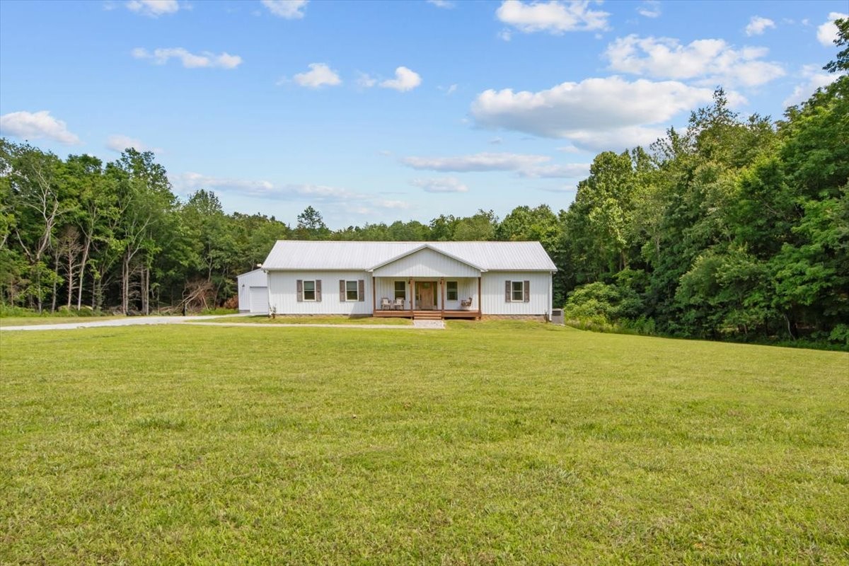 1119 Gallion Road Cumberland Furnace, TN 37051 - Photo 2 of 32 a front view of a house with a garden