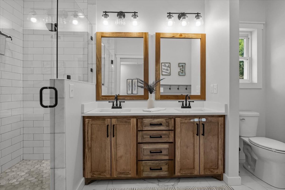 1119 Gallion Road Cumberland Furnace, TN 37051 - Photo 25 of 32 a bathroom with a double vanity sink a large mirror and a shower
