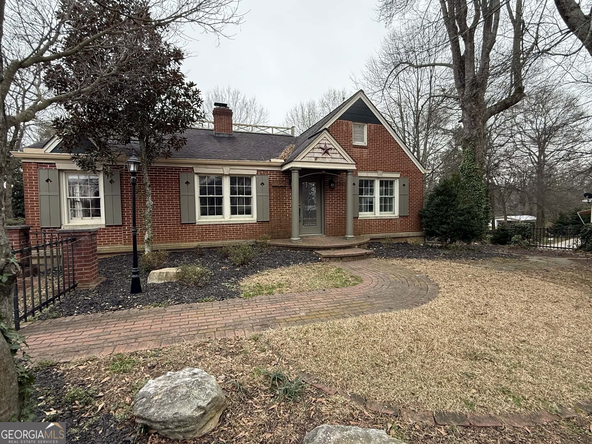 952 Wayside Street Northwest Cornelia, GA 30531 - Photo 2 of 46 a front view of a house with a yard and garage