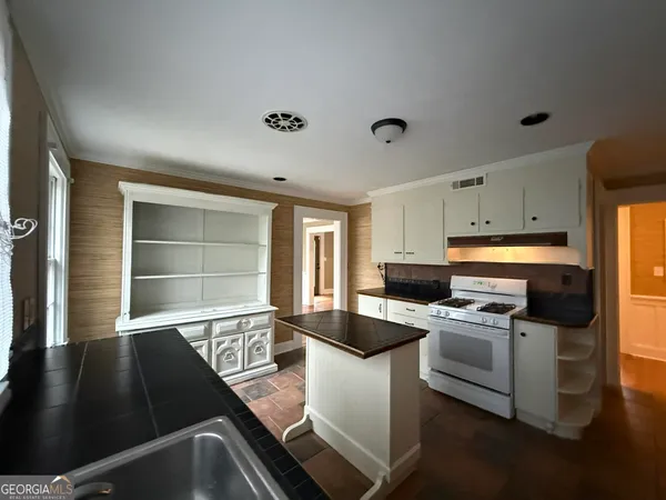 a kitchen with a sink appliances and cabinets