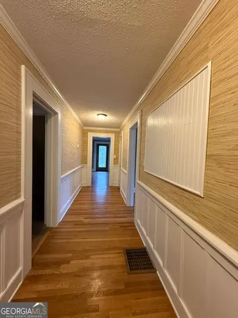 a view of a hallway with wooden floor