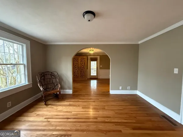 a view of a room with wooden floor and windows
