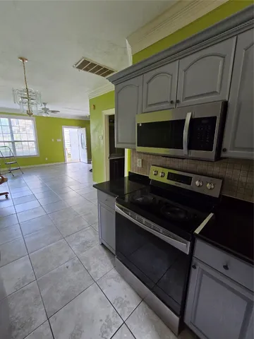 a kitchen with a stove and a microwave
