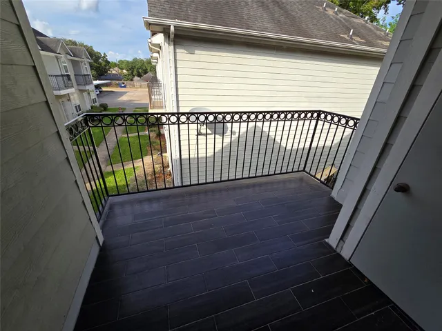 a view of balcony with wooden floor