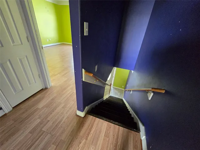 a view of hallway with wooden floor