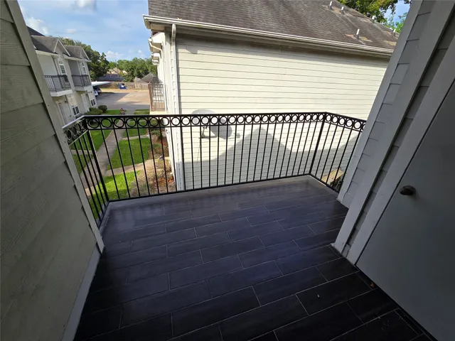 a view of balcony with wooden floor
