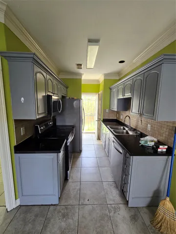 a kitchen with a stove and a refrigerator