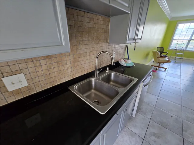 a kitchen with a sink stainless steel appliances and a counter top space