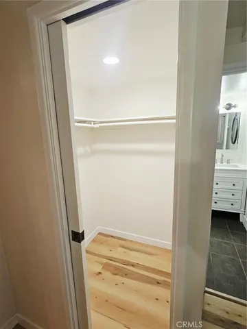 a bathroom with a mirror vanity and a sink