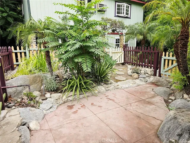 a view of a chair and tables in the back yard of the house
