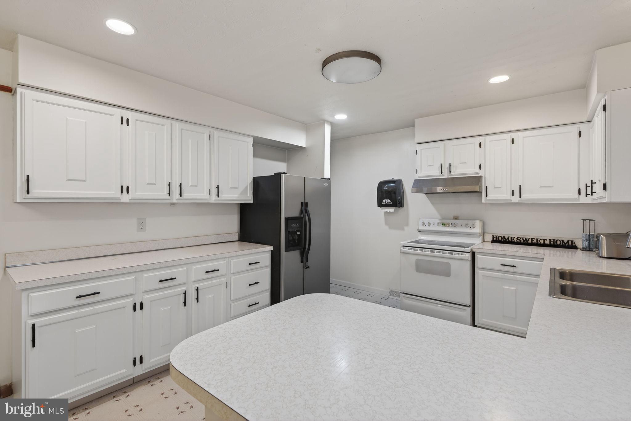 2210 Berkshire Road Lancaster, PA 17603 - Photo 14 of 68 a kitchen with white cabinets and stainless steel appliances