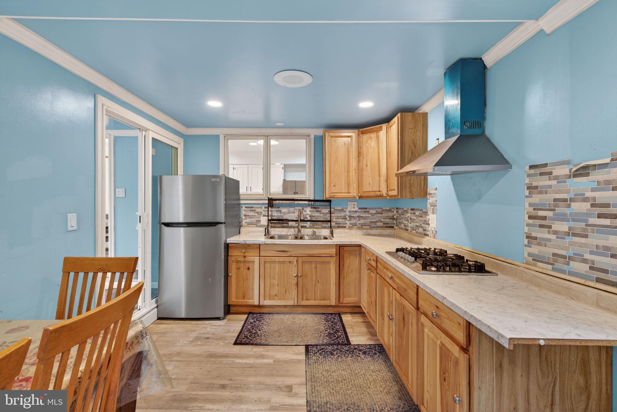2210 Berkshire Road Lancaster, PA 17603 - Photo 23 of 68 a kitchen with refrigerator a stove a sink cabinets and wooden floor
