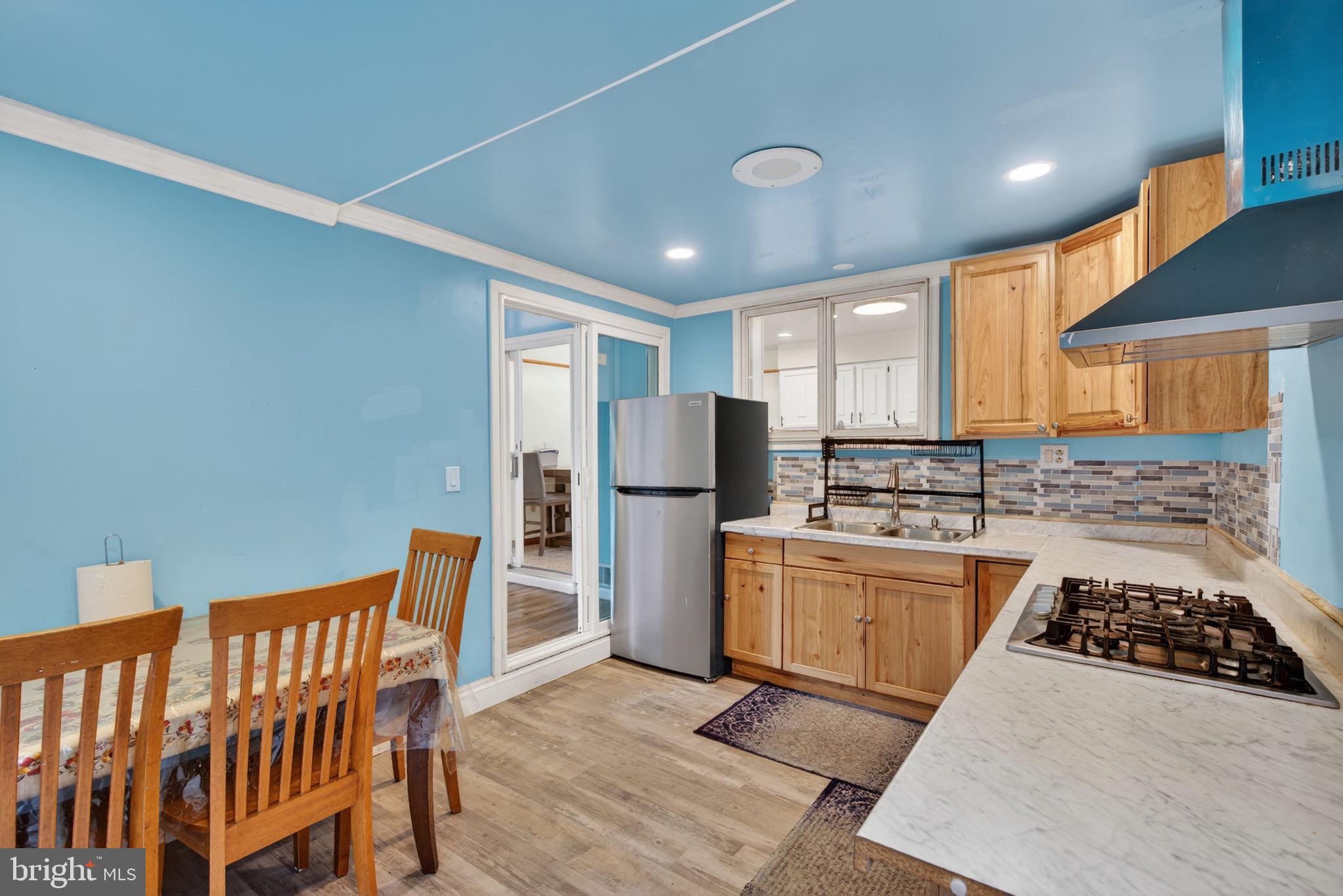 2210 Berkshire Road Lancaster, PA 17603 - Photo 24 of 68 a kitchen with stainless steel appliances granite countertop a stove a sink dishwasher a refrigerator and white cabinets with wooden floor