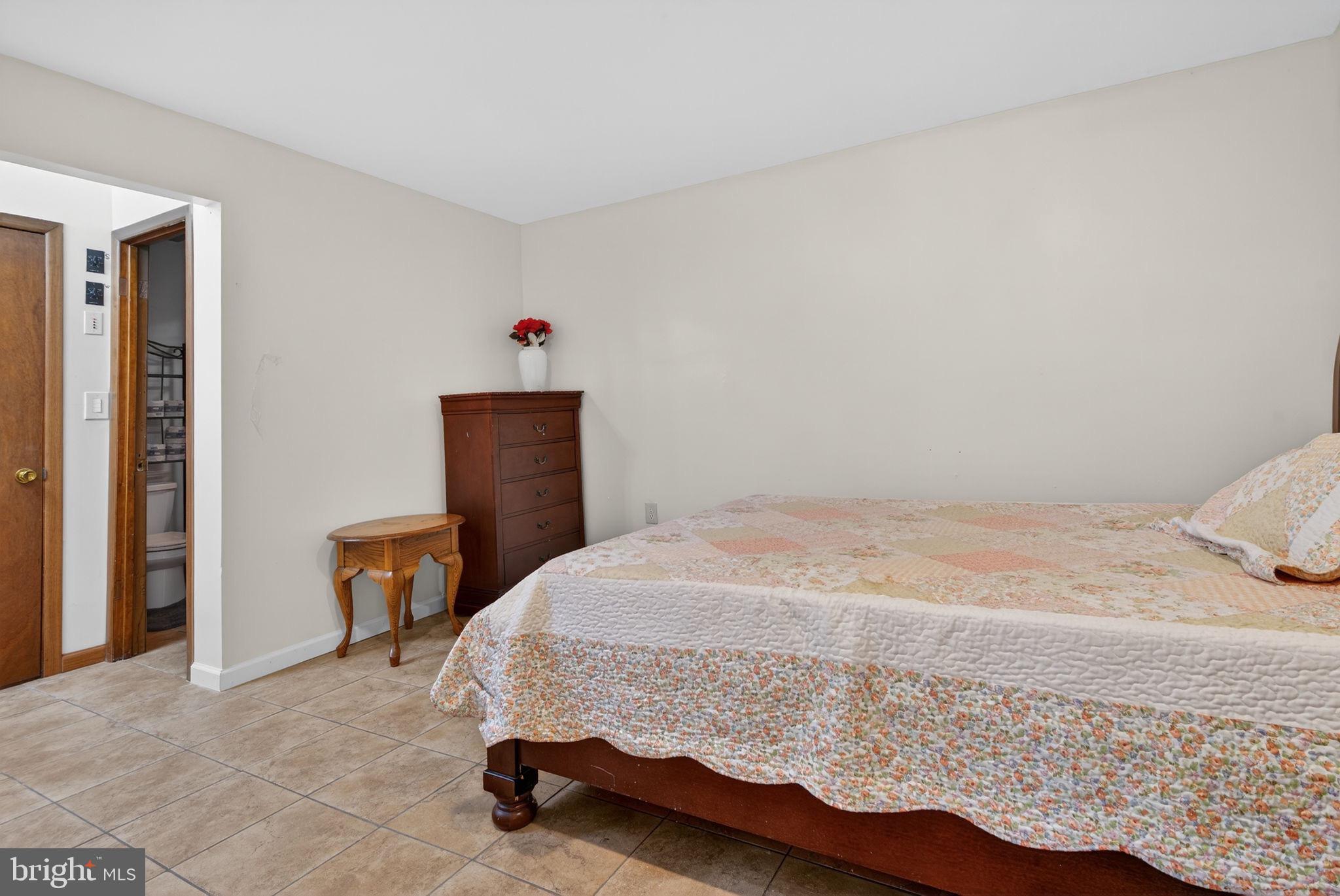 2210 Berkshire Road Lancaster, PA 17603 - Photo 29 of 68 a bedroom with a bed and chair