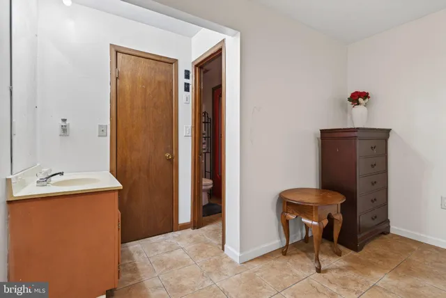 a bathroom with a sink a toilet a mirror and shower