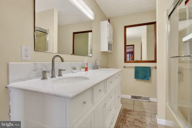 a front view of a house with a garden and plants