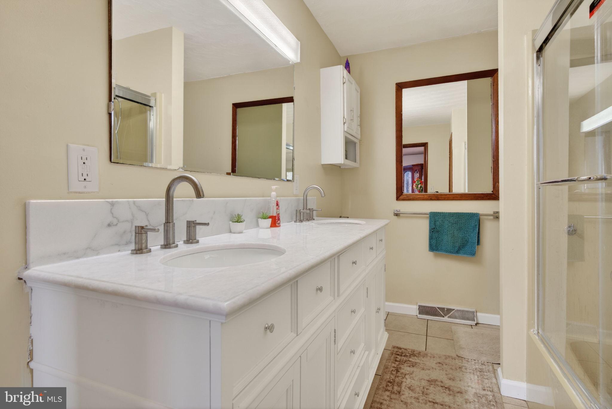 2210 Berkshire Road Lancaster, PA 17603 - Photo 35 of 68 a bathroom with double vanity sink and a mirror