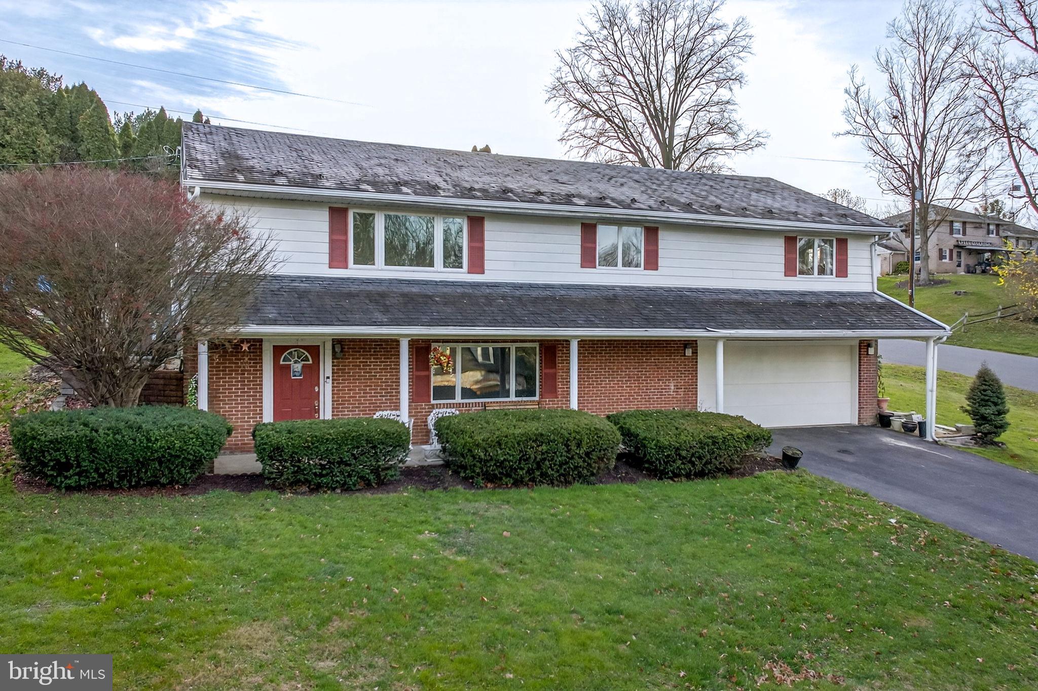 2210 Berkshire Road Lancaster, PA 17603 - Photo 44 of 68 a front view of a house with a garden and plants