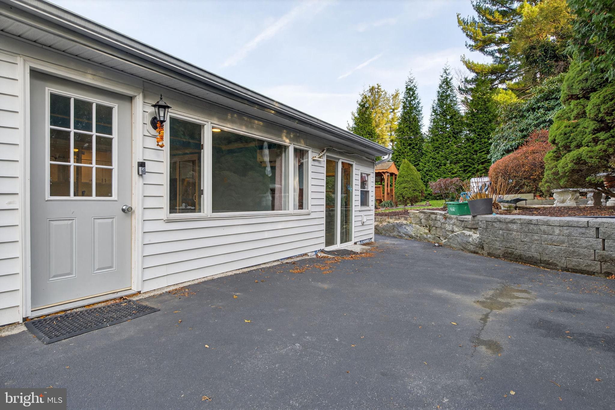 2210 Berkshire Road Lancaster, PA 17603 - Photo 47 of 68 Charming exterior with lush greenery backdrop.