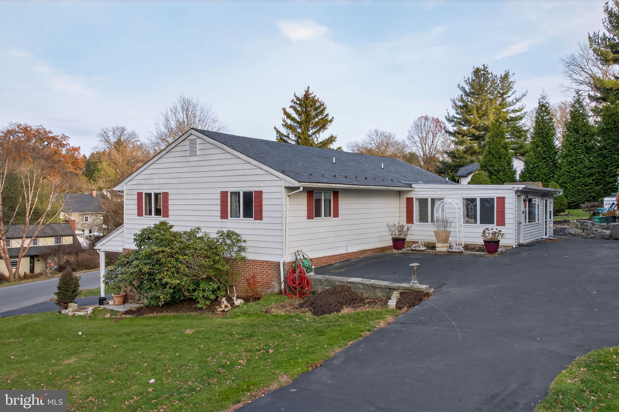 2210 Berkshire Road Lancaster, PA 17603 - Photo 5 of 68 a front view of a house with a garden and plants