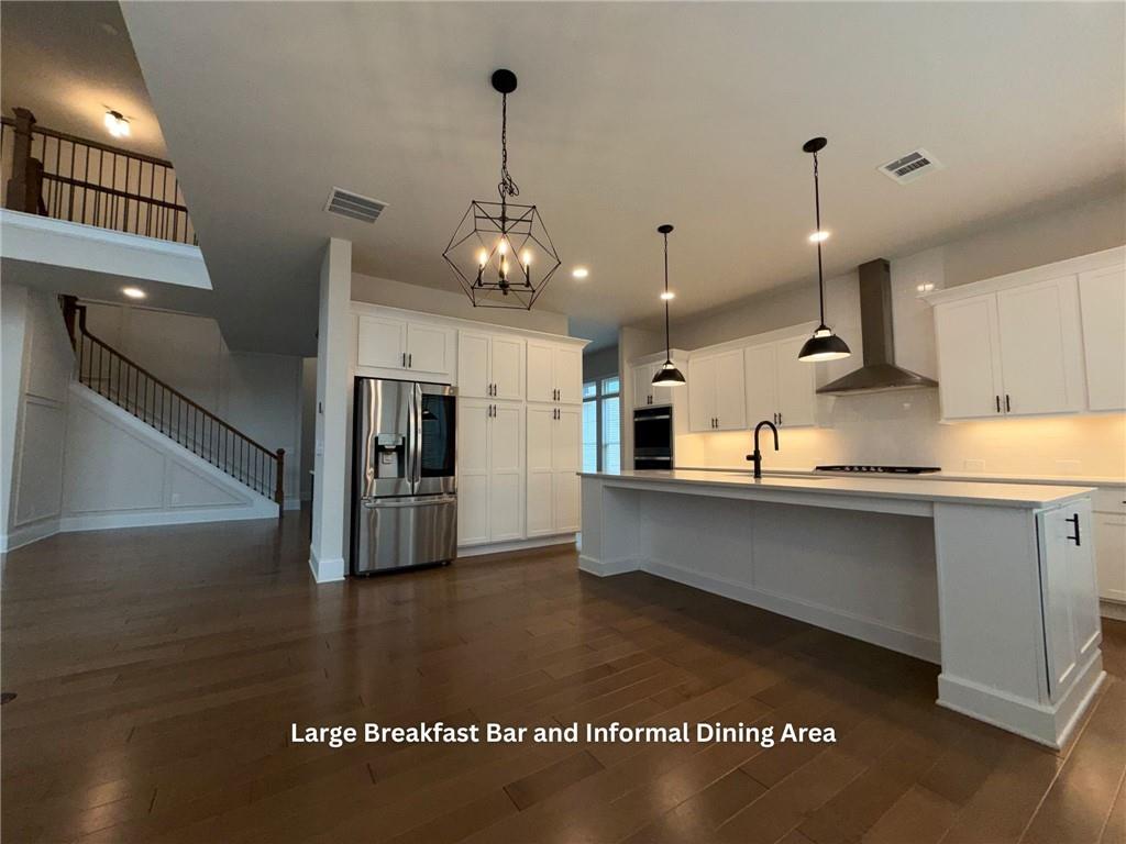 3770 Andover Street Cumming, GA 30028 - Photo 13 of 52 a kitchen with stainless steel appliances granite countertop a sink a stove and a refrigerator